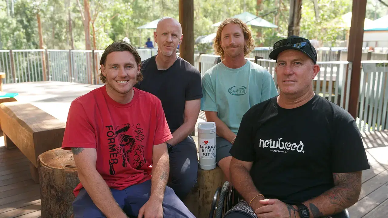Four of the Bite Aid team holding a Shark Bite Kit